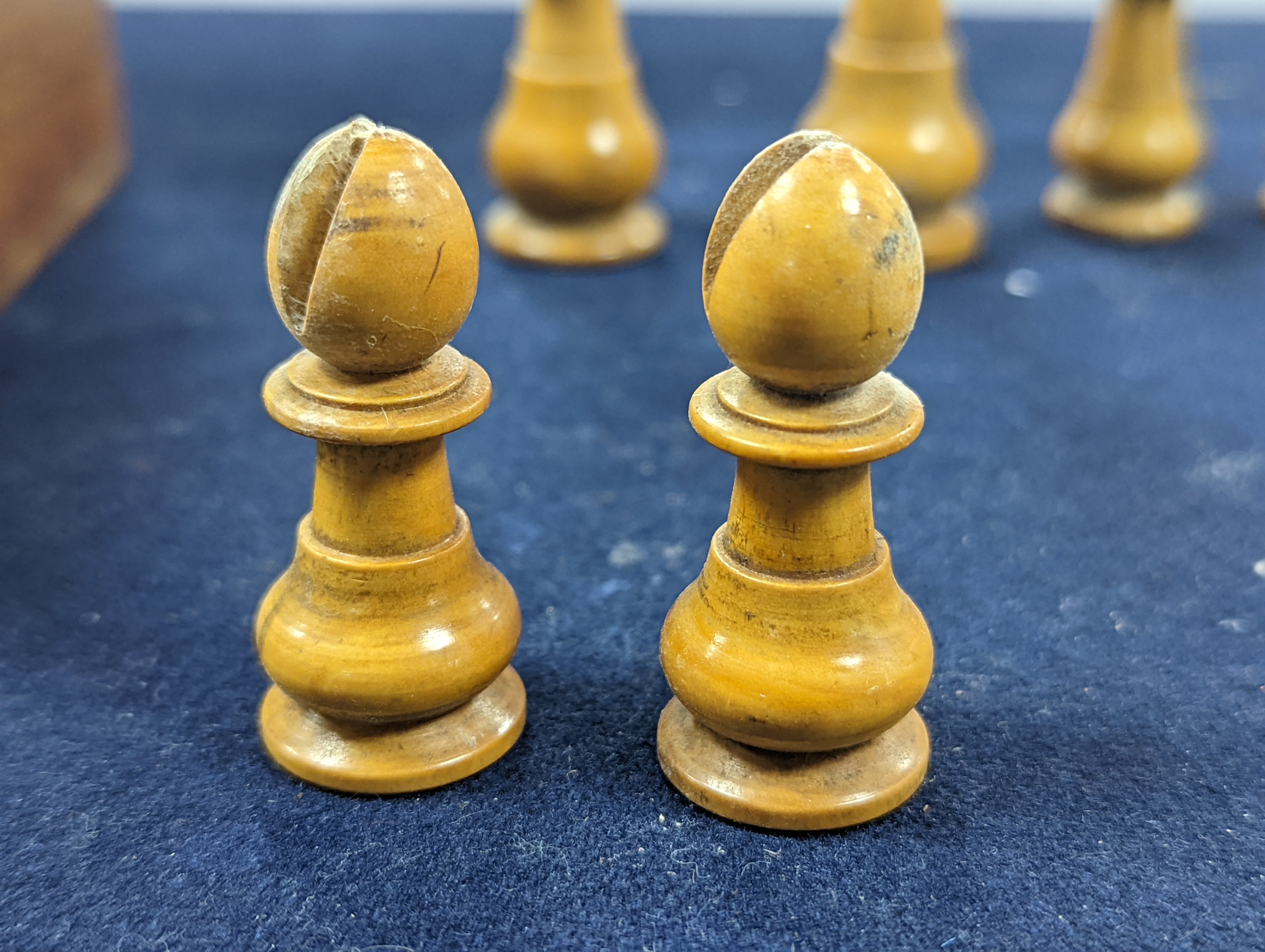 A Victorian brass inset mahogany games box, fitted with solitaire, cribbage, chessmen, draughts etc., 33cm, a turned and stained bone chess set, another games box containing chessmen and draughts